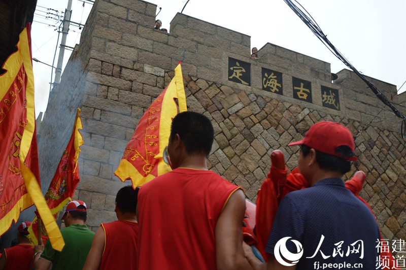 迎送龍頭成為了海上龍舟賽中重要的民俗環(huán)節(jié),許多村民在古城墻上圍觀 李挺攝